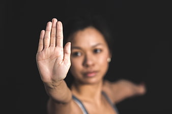 Woman Holding Hand Up Stop Gesture Against Black Background