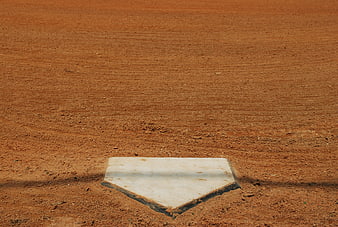 White Home Plate on Red Dirt Baseball Field