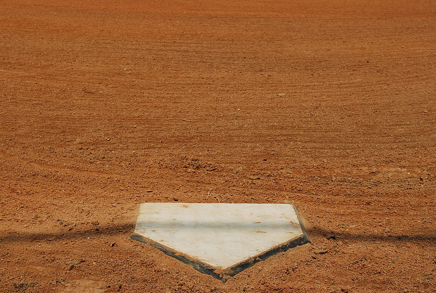 White Home Plate on Red Dirt Baseball Field