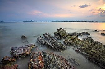 Long Exposure Rocky Coastline at Sunset with Misty Water