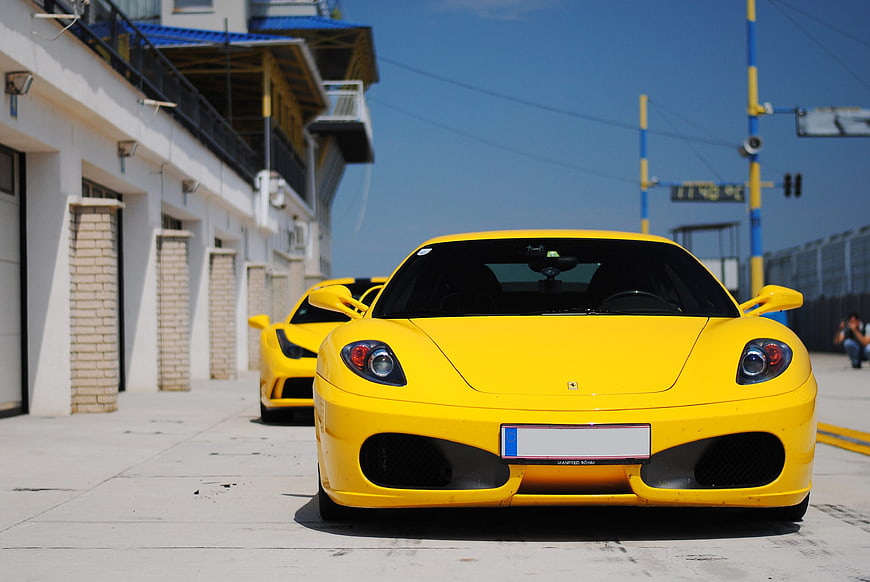 Front View of Yellow Ferrari F430 Sports Car Parked on Street