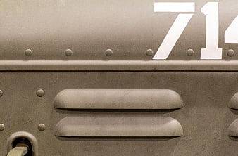 Close-up of vintage military tank armor with rivets and number