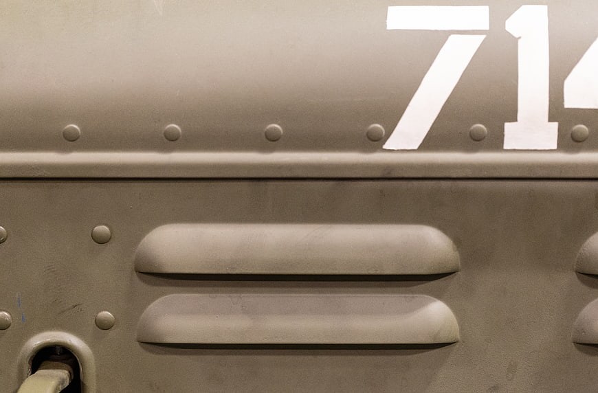 Close-up of vintage military tank armor with rivets and number