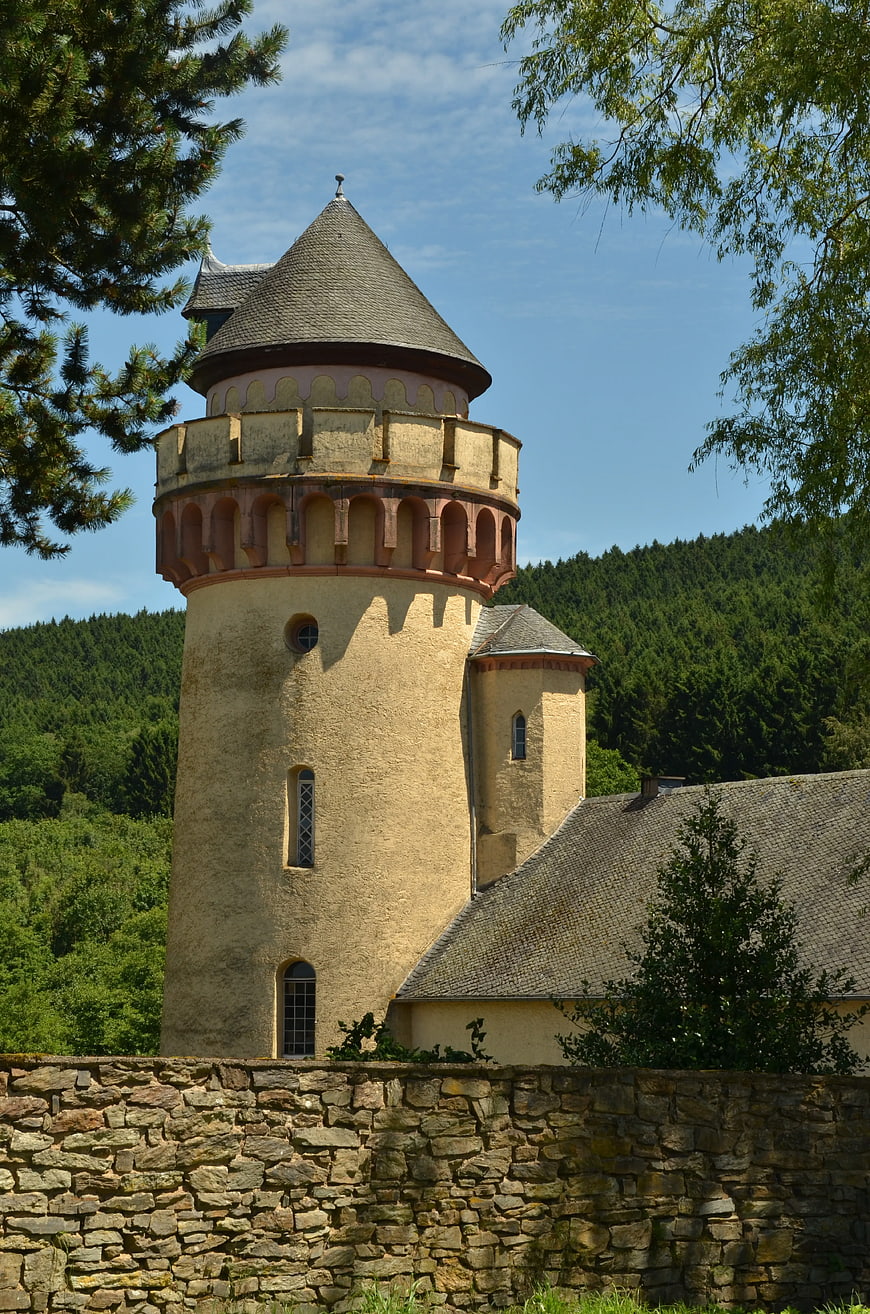 Historic Castle Tower with Conical Roof and Stone Wall