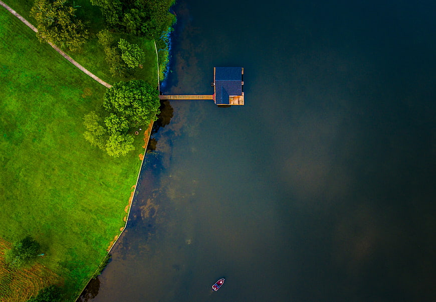 Aerial View of Wooden Dock and Boat on Calm Lake