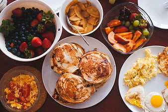 Overhead view of healthy breakfast spread with pancakes and fruit