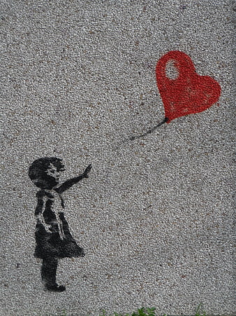 Street art stencil of girl reaching for red heart balloon