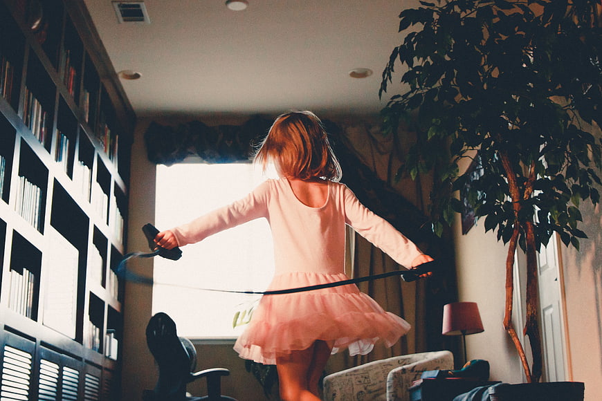 Little Girl Jumping Rope in Living Room