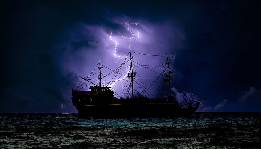 Silhouette of Pirate Ship in Stormy Sea with Lightning