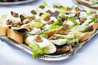 Blue cheese and walnut crostini appetizers on silver tray