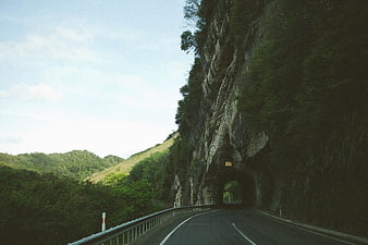 Winding Mountain Road Leading to Rock Tunnel