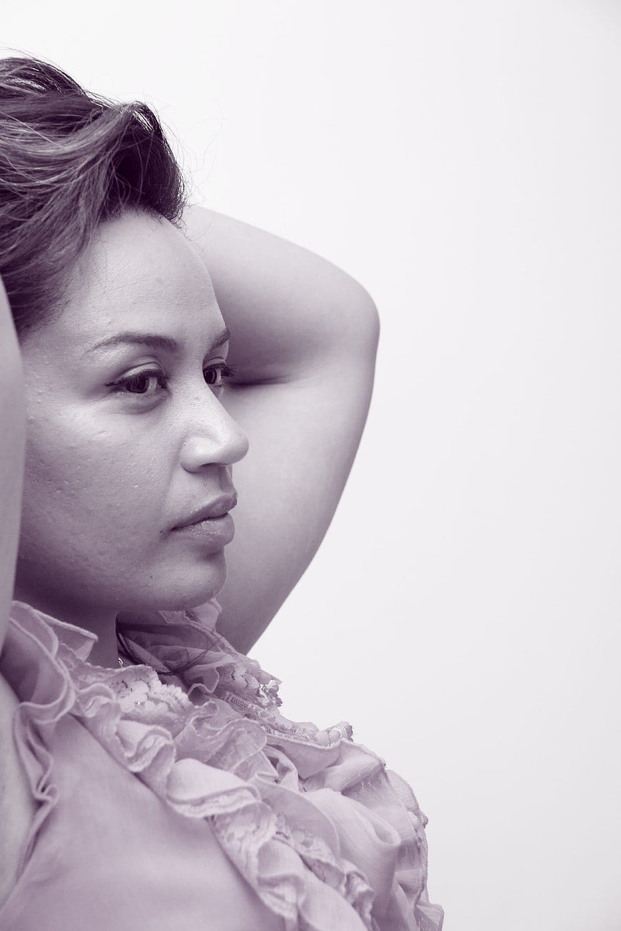 Monochrome Portrait of Woman with Hands Behind Head