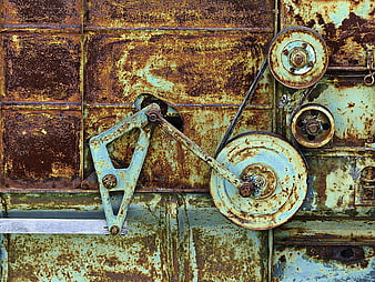 Rusty vintage farm machinery drive mechanism and pulleys
