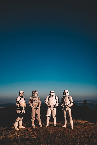 Stormtroopers standing on mountain ridge against blue sky