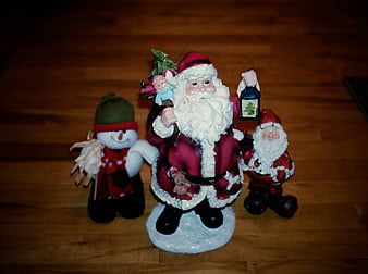 Christmas Santa Claus and Snowman Figurines on Wooden Floor