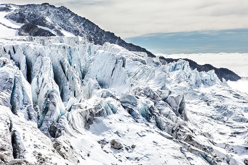 Majestic Glacier Landscape with Jagged Ice Formations and Snowy Peaks