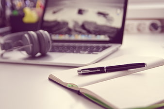 Laptop, Notebook, and Pen on Desk with Headphones