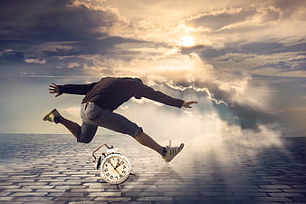 Man jumping over alarm clock on cobblestone path