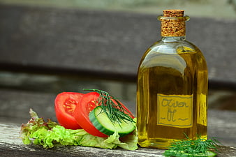 Glass Bottle of Olive Oil with Fresh Salad Ingredients