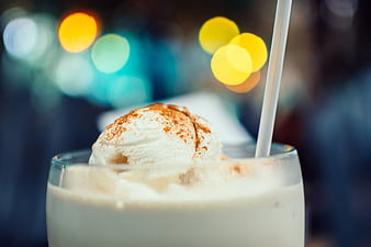 Creamy milkshake with ice cream scoop and cinnamon dust