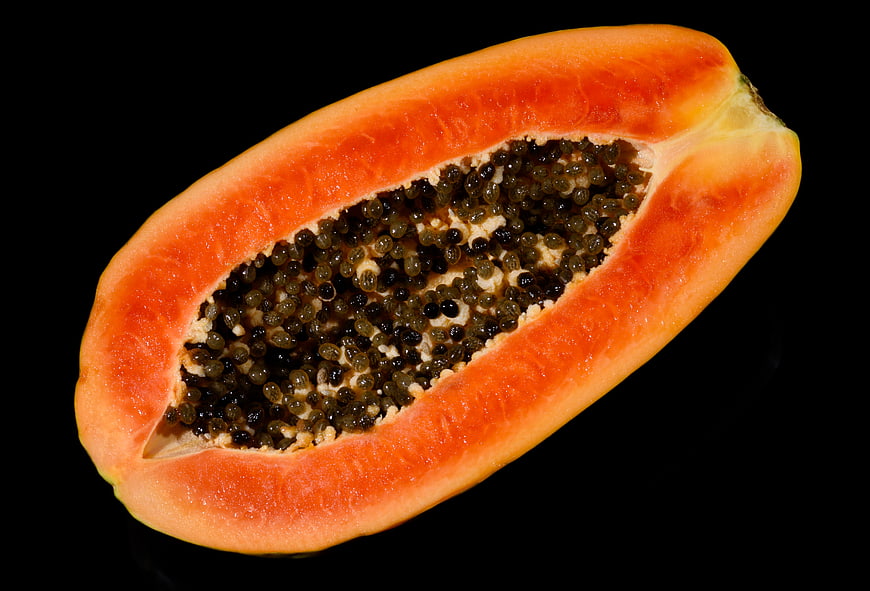 Fresh Halved Papaya with Seeds on Black Background