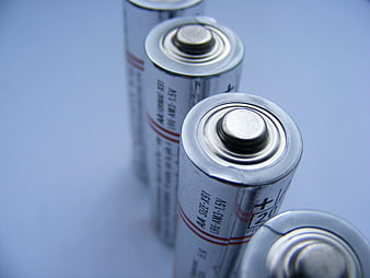 Close-up of AA Alkaline Batteries on Blue Background
