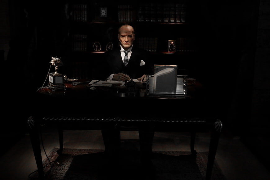 Dramatic Portrait of Man in Suit at Dark Executive Desk