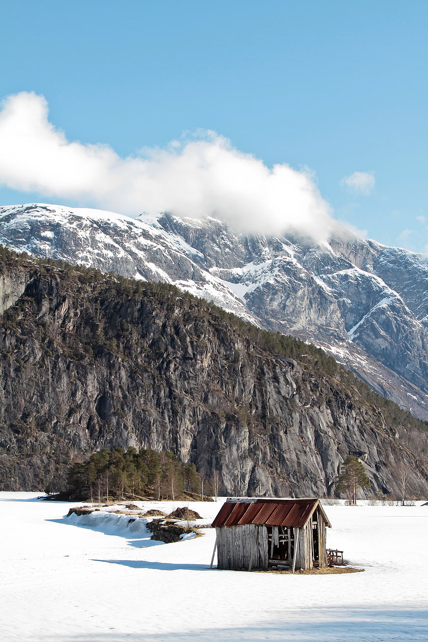 Rustic wooden cabin in snowy mountain landscape