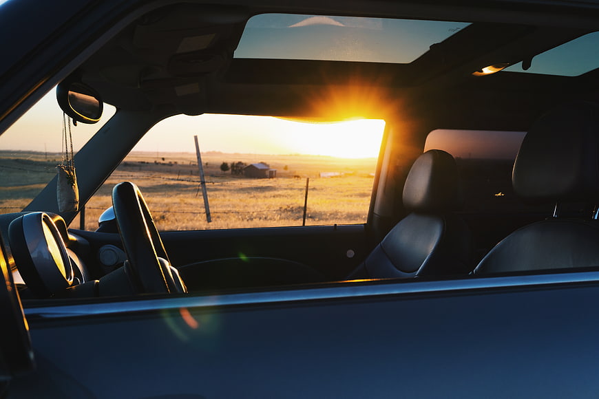 Sunset View from Car Interior with Rural Landscape