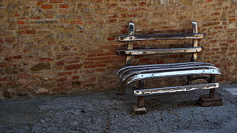 Repurposed Car Bumper Bench Against Weathered Brick Wall