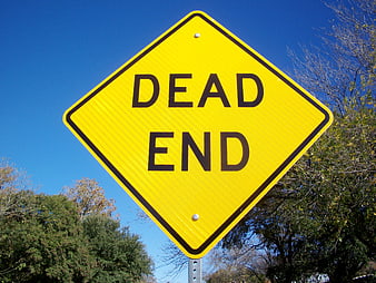 Yellow Dead End Road Sign Against Blue Sky
