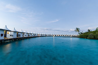 Row of Overwater Bungalows in Maldives at Dusk