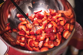 Chopped fresh strawberries in stainless steel mixing bowl