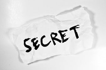 Handwritten Secret Word On Crumpled White Paper
