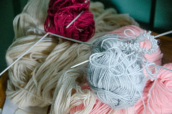 Colorful yarn balls and knitting needles close up