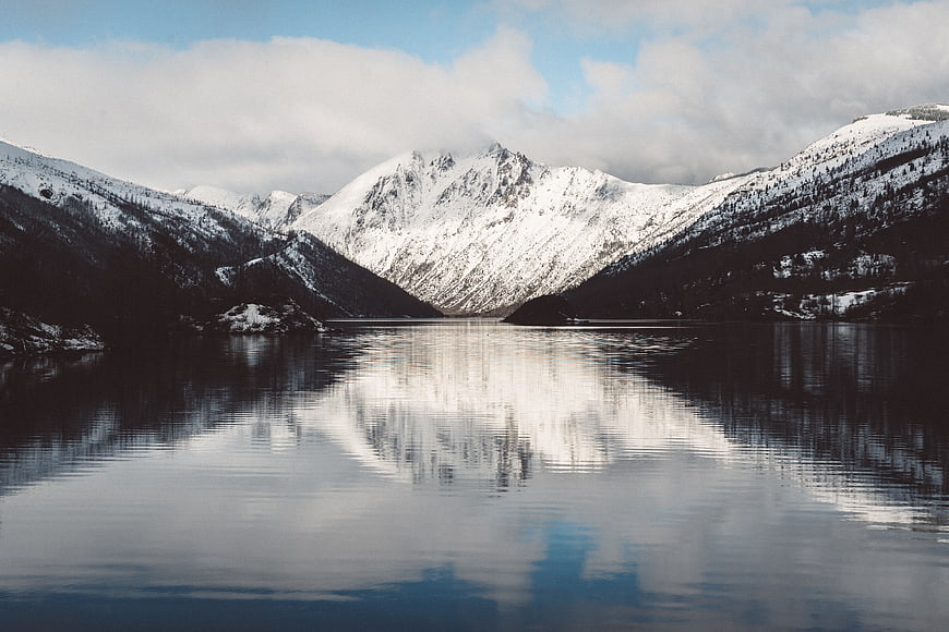 Serene Winter Mountain Lake with Snowy Peaks and Reflection