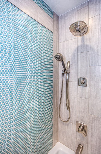 Modern shower with blue mosaic tiles and brushed nickel fixtures