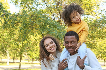 Happy African American Family Portrait in Autumn Park