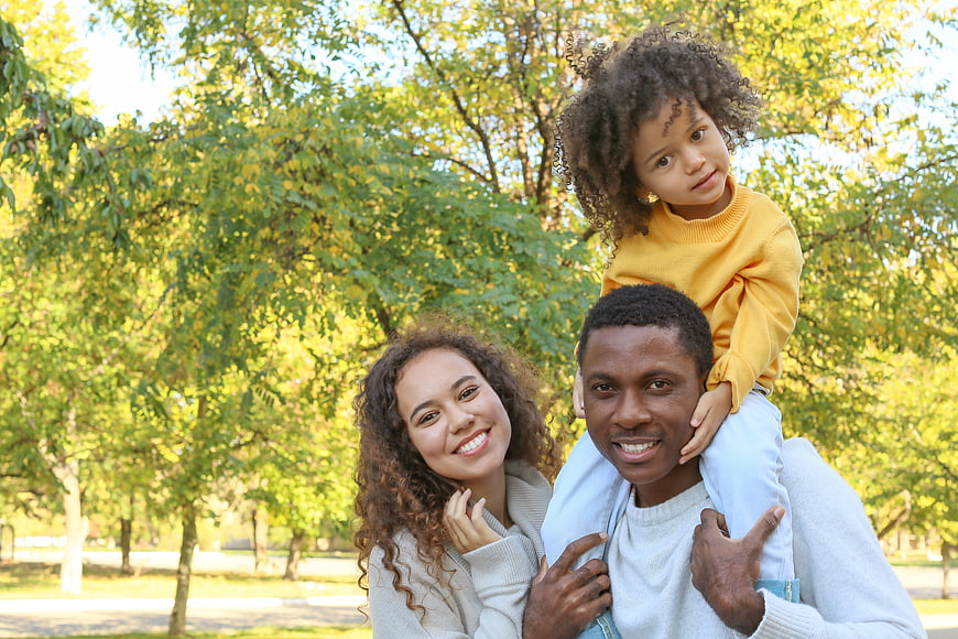Happy African American Family Portrait in Autumn Park