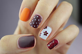 Colorful Autumn Nail Art Design with Floral and Polka Dot Patterns