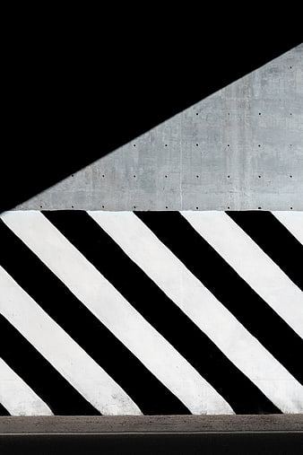 Abstract black and white diagonal stripes on concrete wall