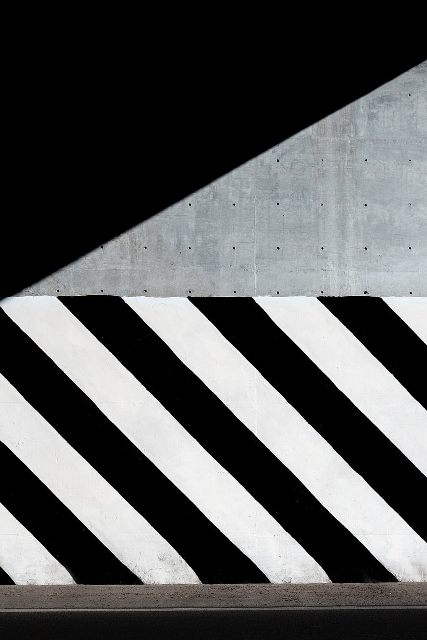 Abstract black and white diagonal stripes on concrete wall