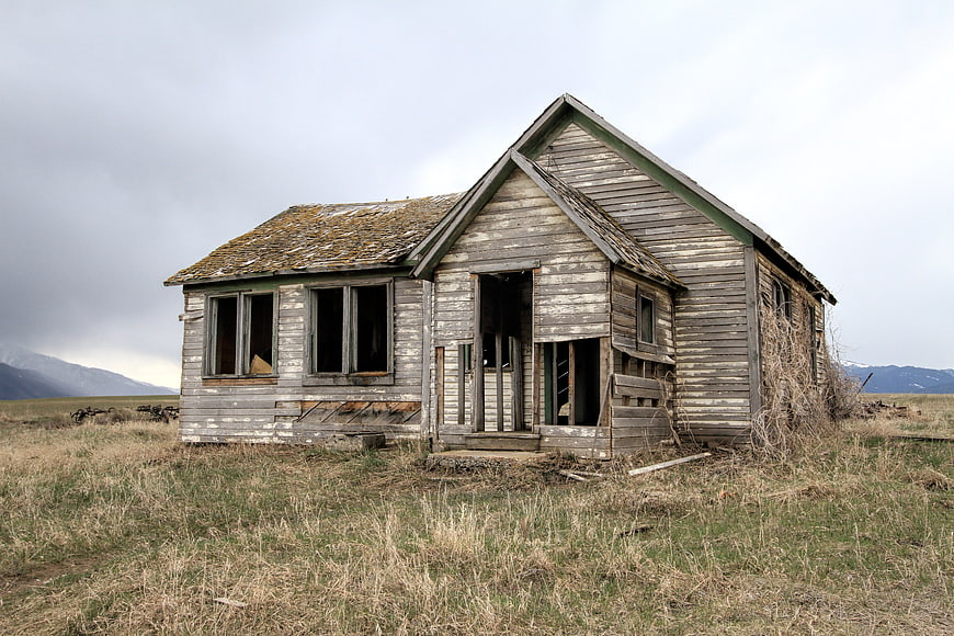 Abandoned Weathered Wooden Farmhouse in Rural Landscape