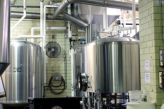 Stainless steel brewing tanks in industrial brewery interior