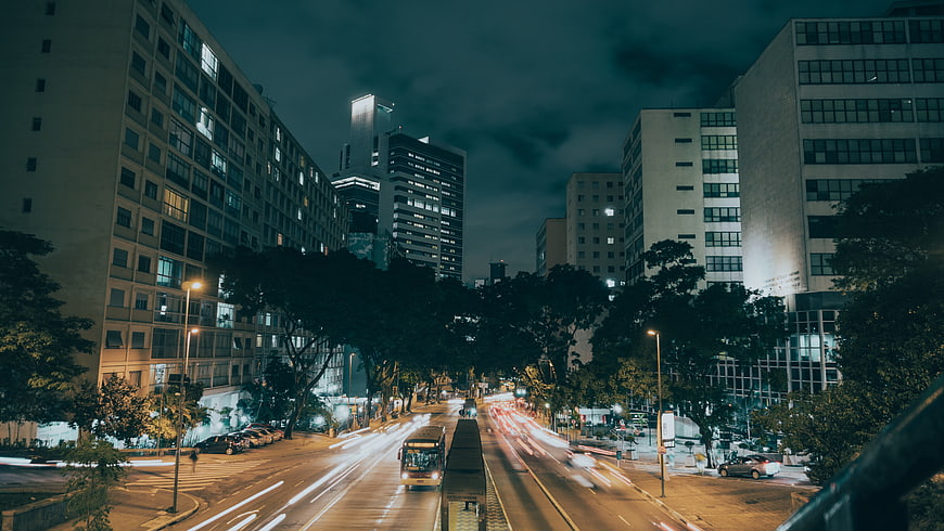 Night cityscape with long exposure light trails on urban street