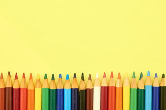 Colorful Colored Pencils on Yellow Background