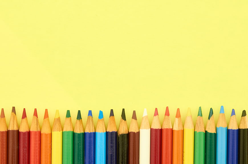 Colorful Colored Pencils on Yellow Background