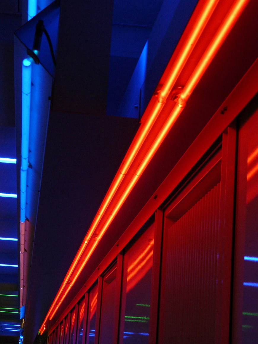 Abstract Red and Blue Neon Lights on Urban Architecture at Night
