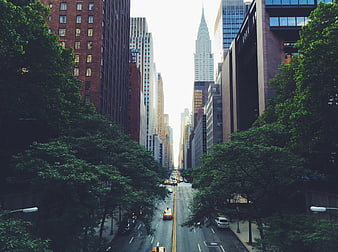 New York City street view with Chrysler Building and yellow taxis