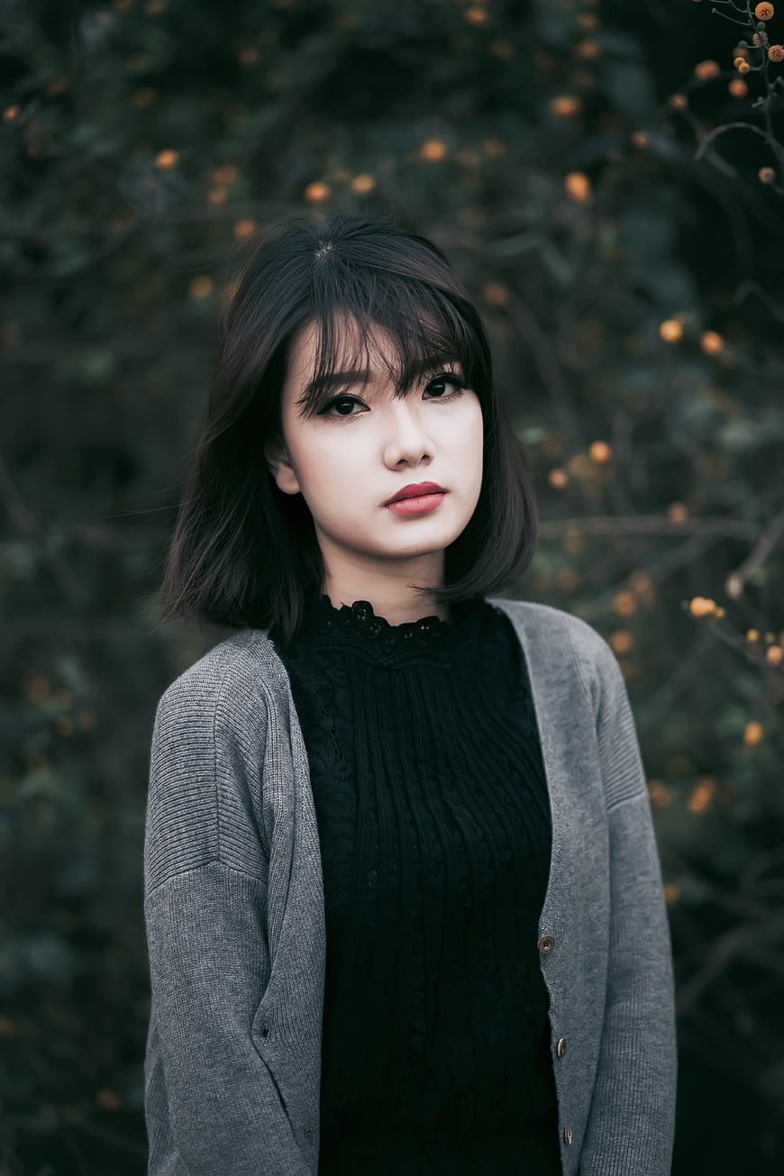 Portrait of Asian Woman in Grey Cardigan Outdoors